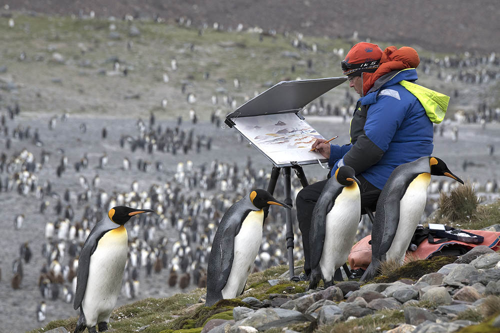 artist painting at his easel surrounded by penguins